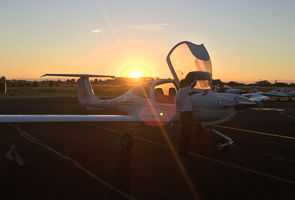 Sunset and a plane in the foreground