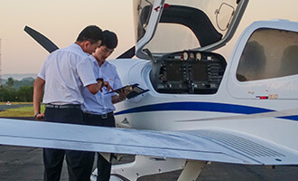 Two students inspecting a Diamond plane